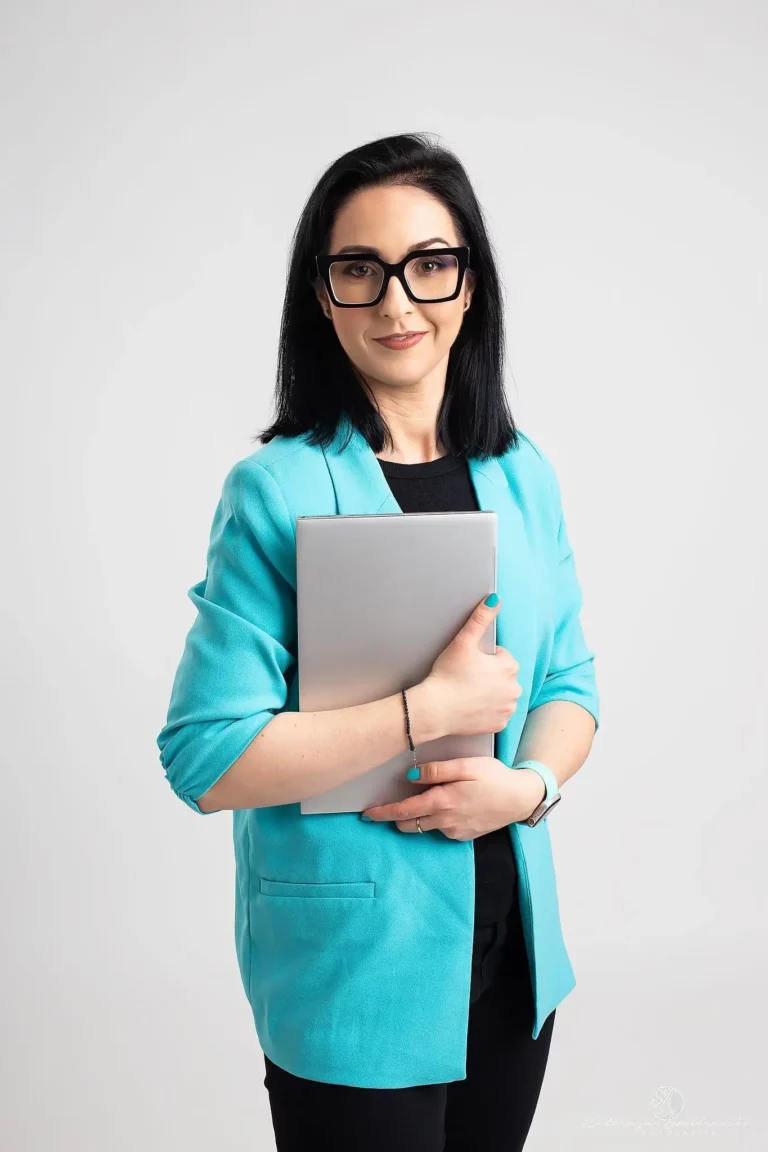 Monika Myca z zamkniętym laptopem w ręku